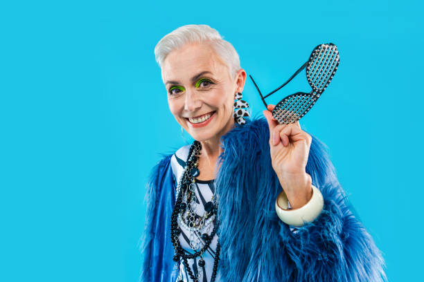 Fashionable woman with grey hair and blue eyes showcasing a royal blue outfit